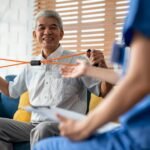 Asian senior elderly man doing physiotherapist with support from nurse.