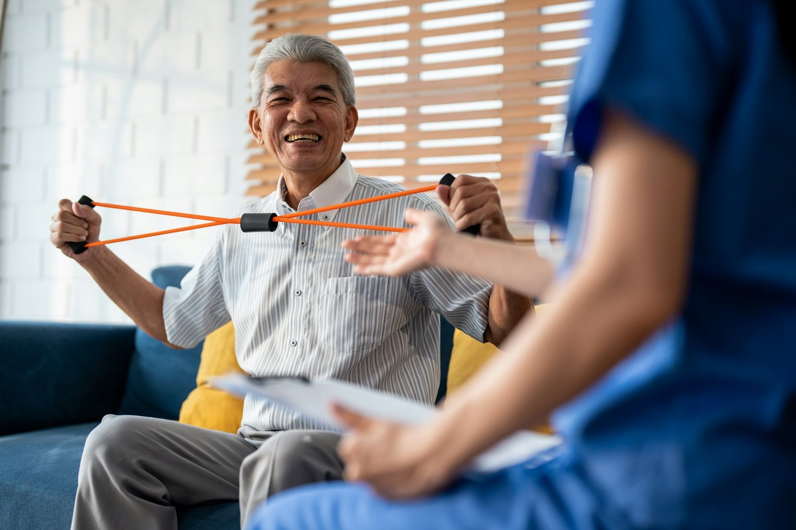 Asian senior elderly man doing physiotherapist with support from nurse.