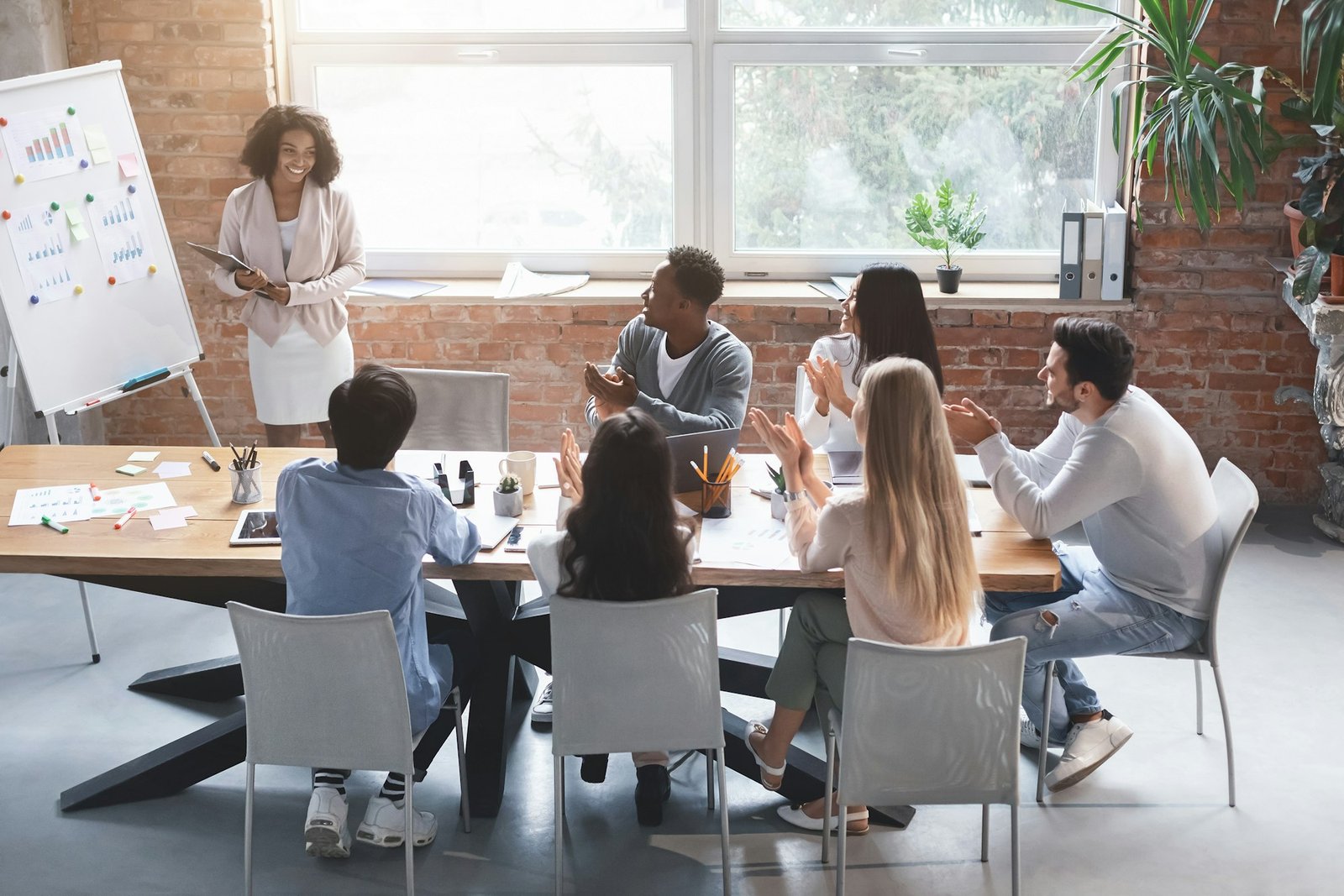 Black woman making marketing presentation to international business team