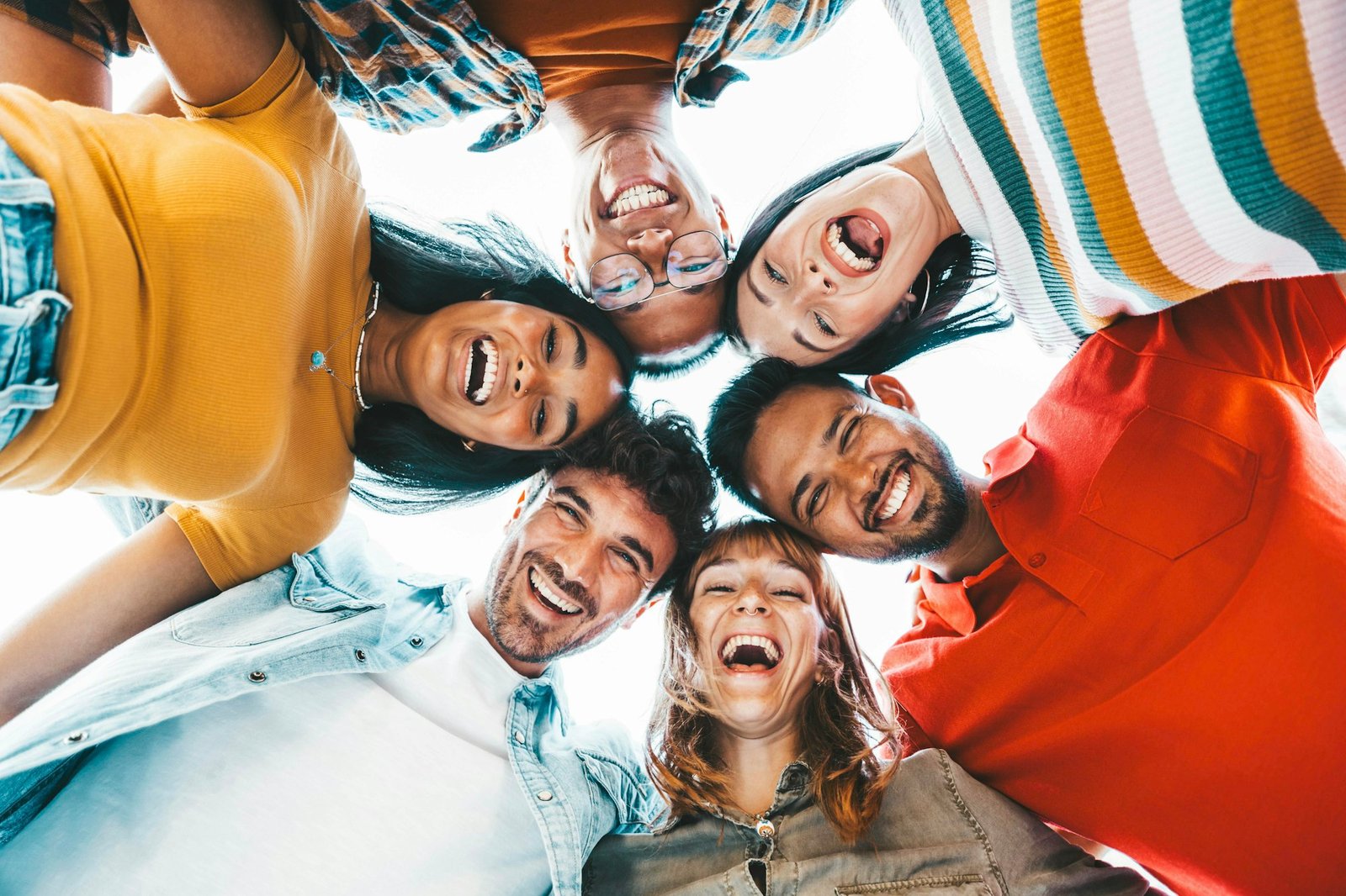 Multicultural community of young people smiling at camera outside